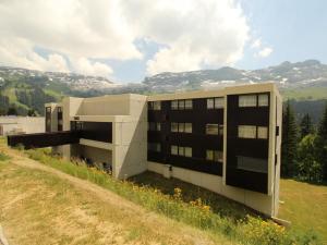 a building on top of a hill with a field at Studio rénové à Flaine Forêt, résidence Sirius, à 500m des pistes – 5 couchages - FR-1-687-17 in Arâches-la-Frasse