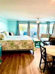 a bedroom with a bed and a living room at Cedar Key Islands Dolphins Cay Condo 230 in Cedar Key