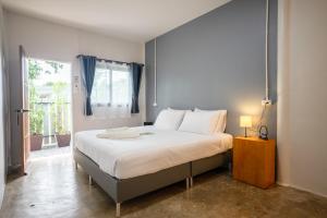 a bedroom with a large bed and a window at Fix 25 House Koh Kood in Ban Khlong Mat
