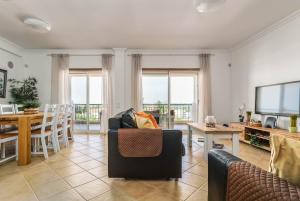 a living room with a couch and a table at Bright 3-BR in Guia with Shared Pool by Lisbeyond in Guia