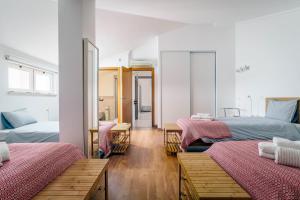 a room with two beds and a mirror at Bright 3-BR in Guia with Shared Pool by Lisbeyond in Guia +31 photos