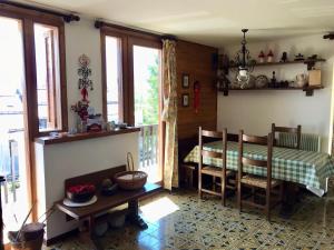 a bedroom with a bed and a balcony with windows at Appartamento Dolomiti con parcheggio privato coperto in Folgarida
