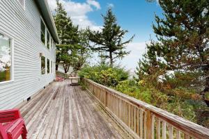 a wooden deck with a bench on the side of a house at Cliffside Serenity in Oceanside