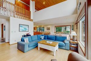a living room with a blue couch and a table at Cliffside Serenity in Oceanside