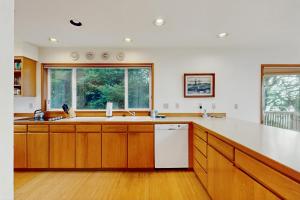 a large kitchen with a sink and a window at Cliffside Serenity in Oceanside +19 photos