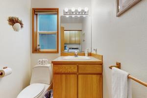 a bathroom with a sink and a toilet and a mirror at Cliffside Serenity in Oceanside +20 photos