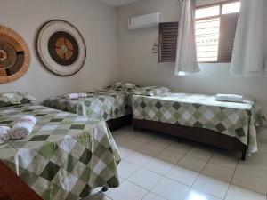 una stanza con due letti singoli e una finestra di Casa super arejada no melhor de Miramar a João Pessoa