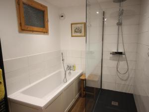 a bathroom with a bath tub and a shower at Chalet confortable avec billard, cheminée et Wifi à Vallandry - FR-1-411-545 in Landry +6 photos