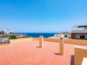 a brick patio with the ocean in the background at Ek coast la jaca in La Jaca