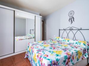 a bedroom with a bed with a floral bedspread at Ek coast la jaca in La Jaca