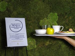 a tray with a plate of food and a plate of fruit at ibis Paris Pantin Eglise in Pantin