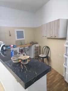 a kitchen with a counter with two baskets on it at Mechi House in Djerba +2 photos