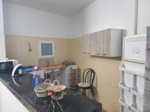 a kitchen with a table with baskets on it at Mechi House in Djerba