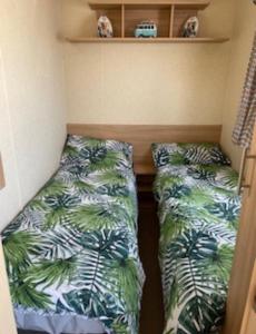 een kamer met 2 bedden in een kleine kamer bij 6 Berth, Pet friendly caravan with Decking - Great Yarmouth in Great Yarmouth