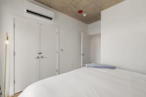 a bedroom with white cabinets and a bed at Stylish 3BR Gem in Prime Location in Chicago +10 photos