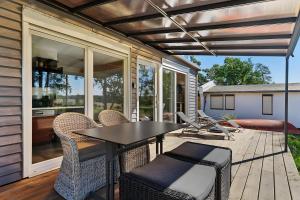 a patio with a table and chairs on a deck at Ferienhaus 110 in Stelzendorf