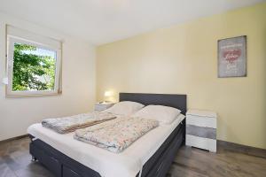 a large bed in a room with a window at Ferienhaus 110 in Stelzendorf