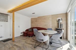 a living room with a table and chairs and a couch at Ferienhaus 110 in Stelzendorf