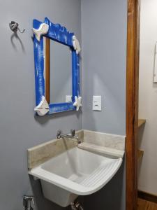 a bathroom with a white sink and a mirror at Cedro Rosa in Guarapari +15 photos