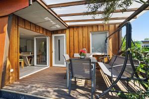 a wooden deck with a table and chairs on it at Ferienhaus 36 in Stelzendorf
