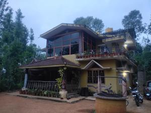a house with a motorcycle parked in front of it at Wood stone step in Napoklu