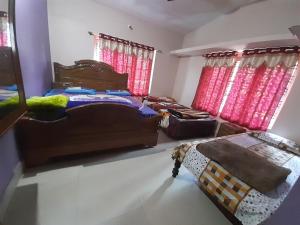 a bedroom with two beds and red curtains at Wood stone step in Napoklu