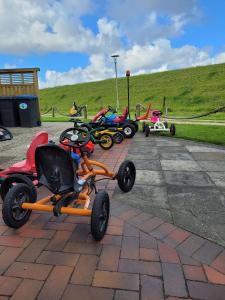 a row of childrens tricycles parked on a sidewalk at Ferienhaus Landskron in Wangerland