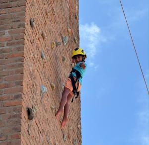 a boy on the climbing wall of a brick building at Hotel Casa Grande Gravatá in Gravatá +102 photos