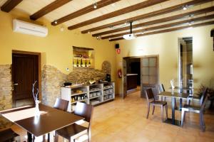 une salle à manger avec des plafonds en bois, des tables et des chaises dans l'établissement Hotel Can Panyella, à Gélida
