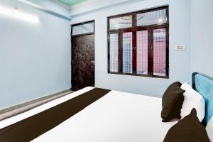 Voodi või voodid majutusasutuse Hotel O Om Sai Garden toas