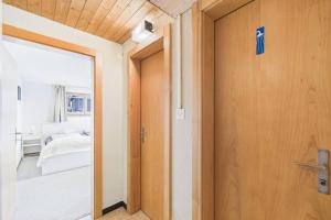 a door leading to a bedroom with a bed at Comfortable studio near Saas-Fee ideal for couples in Saas-Grund