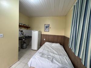 a small bedroom with a bed and a sink at Residencial Dom Luiz in Belém +28 photos