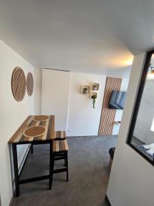 a dining room with a table and a room at Sweet Cocon Studio in Étampes-sur-Marne