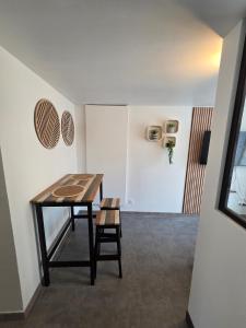 a dining room with a table and a chair at Sweet Cocon Studio in Étampes-sur-Marne