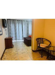 a living room with a chair and a table at Lookout Star Legend Accommodation in Parow +13 photos