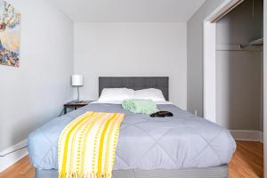 a bed with two towels on top of it at Jungle House Luxury Stays - Columbus Downtown Short North in Columbus