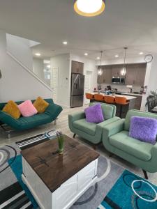 a living room with two couches and a coffee table at Exquisite 4BR & 3 Baths 2000sqft Home in Calgary