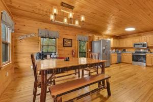 a kitchen with a large wooden table and chairs at Creekside Cabin in Cosby