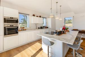 a kitchen with white cabinets and a large island at Villa Il Morino in Centofinestre