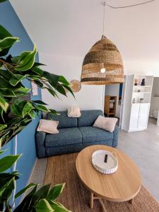 a living room with a couch and a table at La maison du petit large in La Bernerie-en-Retz