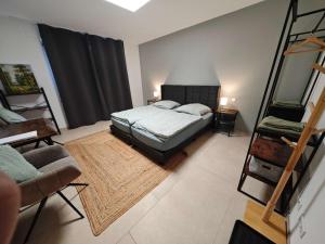 a bedroom with a bed and a ladder in it at Gästehaus Ferienwohnung Zimmer 2A Jülich in Jülich