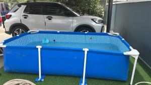 a blue tub sitting in front of a car at Wan Z Homestay Pasir Mas in Pasir Mas +1 photo
