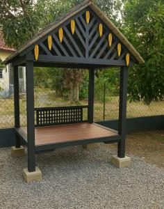 a gazebo with a bench in a park at Wan Z Homestay Pasir Mas in Pasir Mas