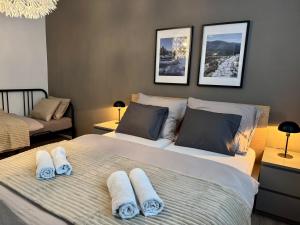 a bedroom with two beds with towels on them at Family Apartment 104 in Špindlerův Mlýn +18 photos