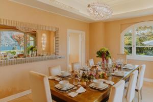 a dining room with a long table and chairs at Villa Aria in San Felice del Benaco