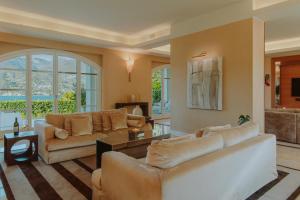 a living room with two couches and a table at Villa Aria in San Felice del Benaco