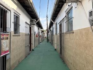 an empty hallway of a school with barred windows at Residencial Dom Luiz in Belém
