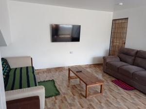 a living room with a couch and a coffee table at Casa en Atuntaqui in Atuntaqui