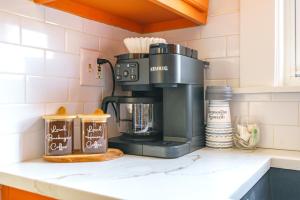 a coffee maker on a counter in a kitchen at Prime Location Top Rated Clean Parking Free! in Columbus +123 photos