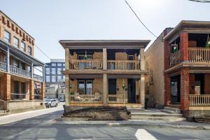 an old brick building with a balcony on a street at Prime Location Top Rated Clean Parking Free! in Columbus